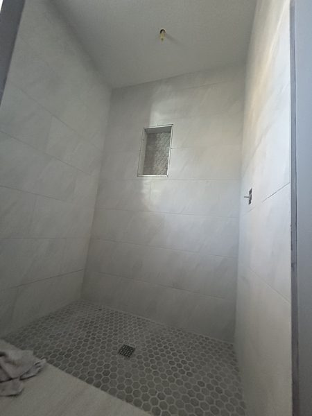 Large-format porcelain tile set on a bathroom wall in Pinellas County, Florida