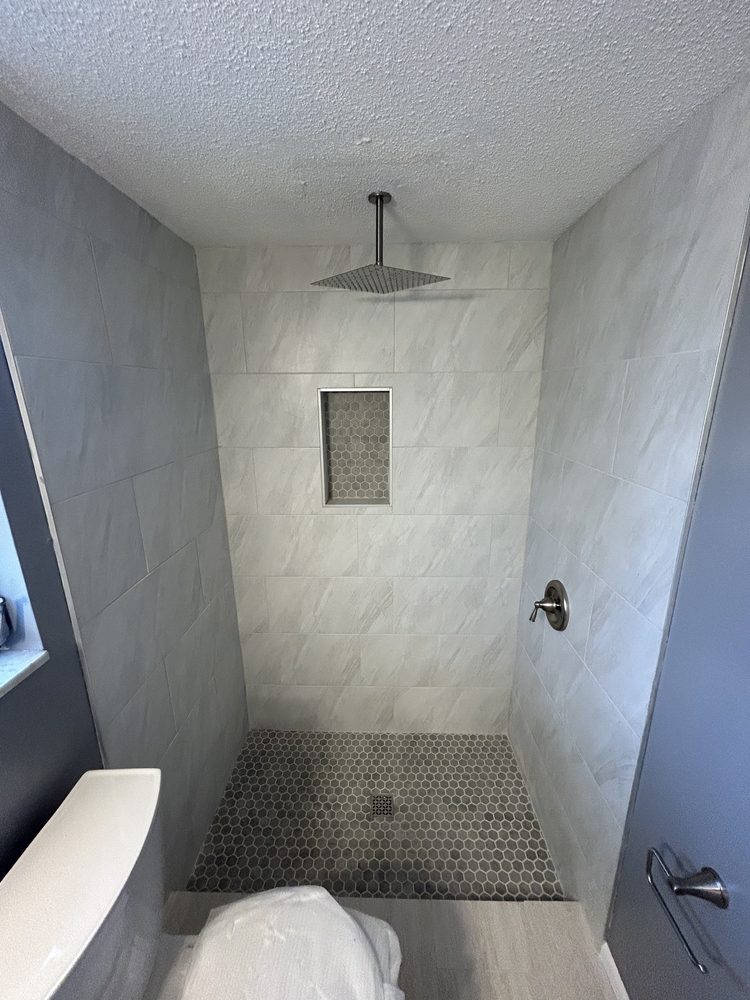 Hexagon mosaic tile shower pan set on a mortar bed in a Pinellas County bathroom