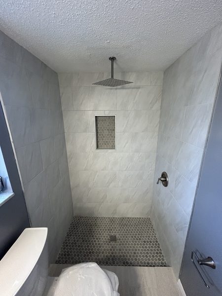 Hexagon mosaic tile shower pan set on a mortar bed in a Pinellas County bathroom