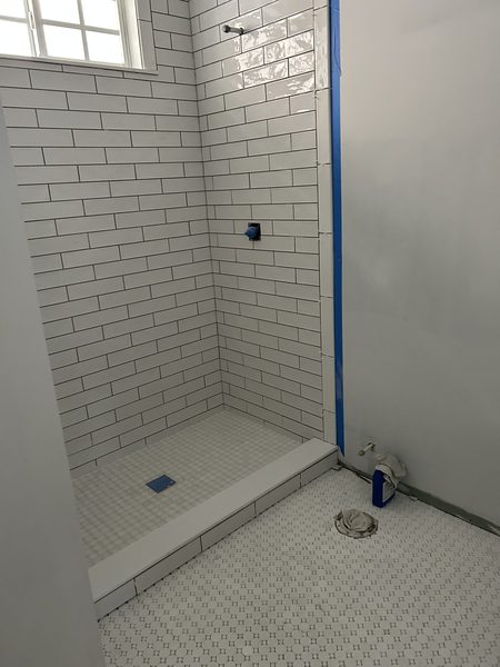 Subway tiled shower with a recessed niche in a Pinellas County bathroom