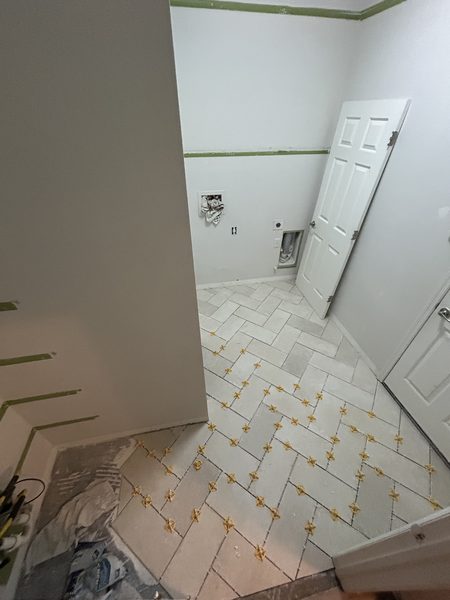 Herringbone floor tile finished in a Pinellas County laundry room