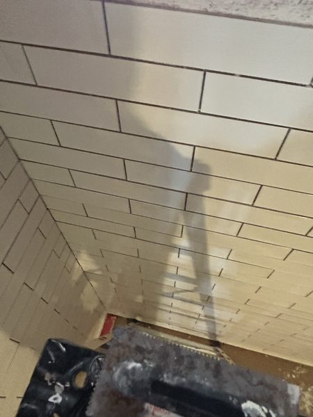 Wall tile being set with spacers during a Pinellas County bathroom remodel